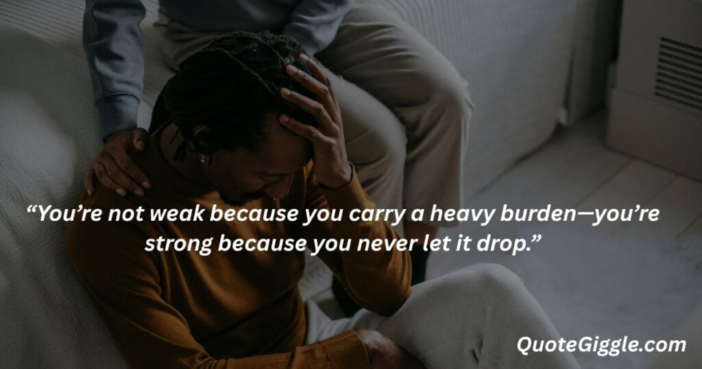 Motivational inspiring quotes for When You Feel Like Life is a Struggle 7 Emotional image of a stressed man with head in hands, being comforted by another person, featuring the quote “You’re not weak because you carry a heavy burden...” by QuoteGiggle.com — best for motivational inspiring quotes for when you feel like life is a struggle.